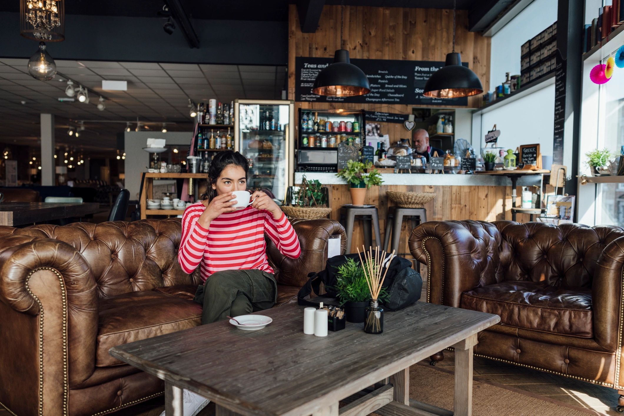 Customer enjoying coffee in a stylish café setting