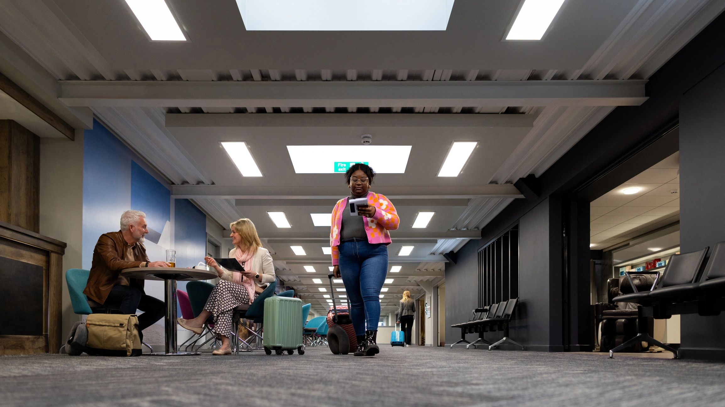 Traveler moving through a modern airport terminal