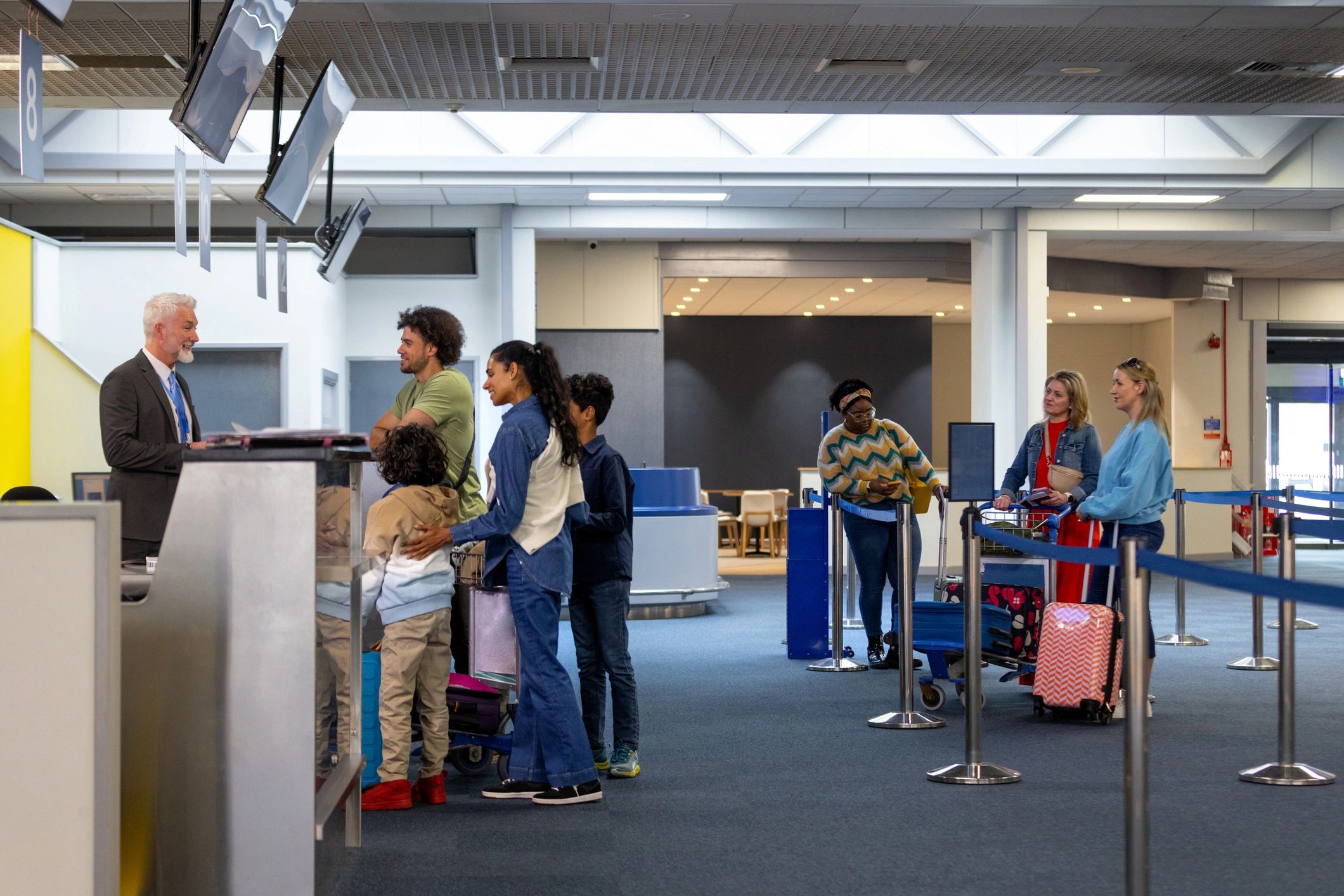 Airport service environment with travelers at a check-in counter