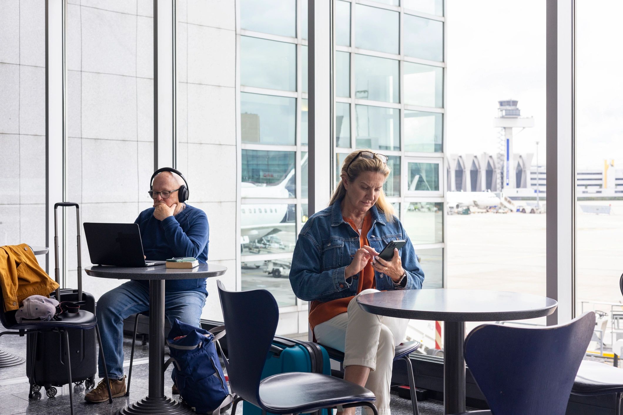 Travelers relaxing in an airport hospitality space