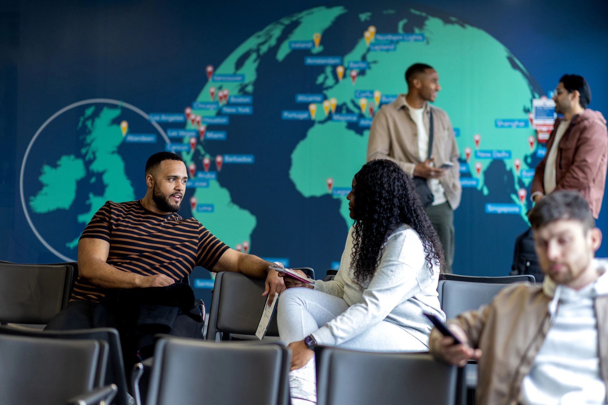 Airport departure lounge with travelers seated in a premium waiting area